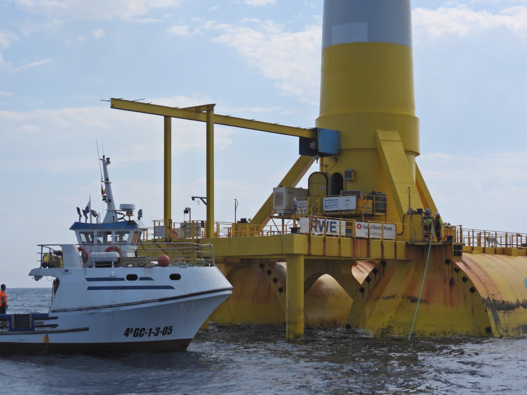 DemoSATH floating wind platform during offshore operations with a support vessel alongside the structure.