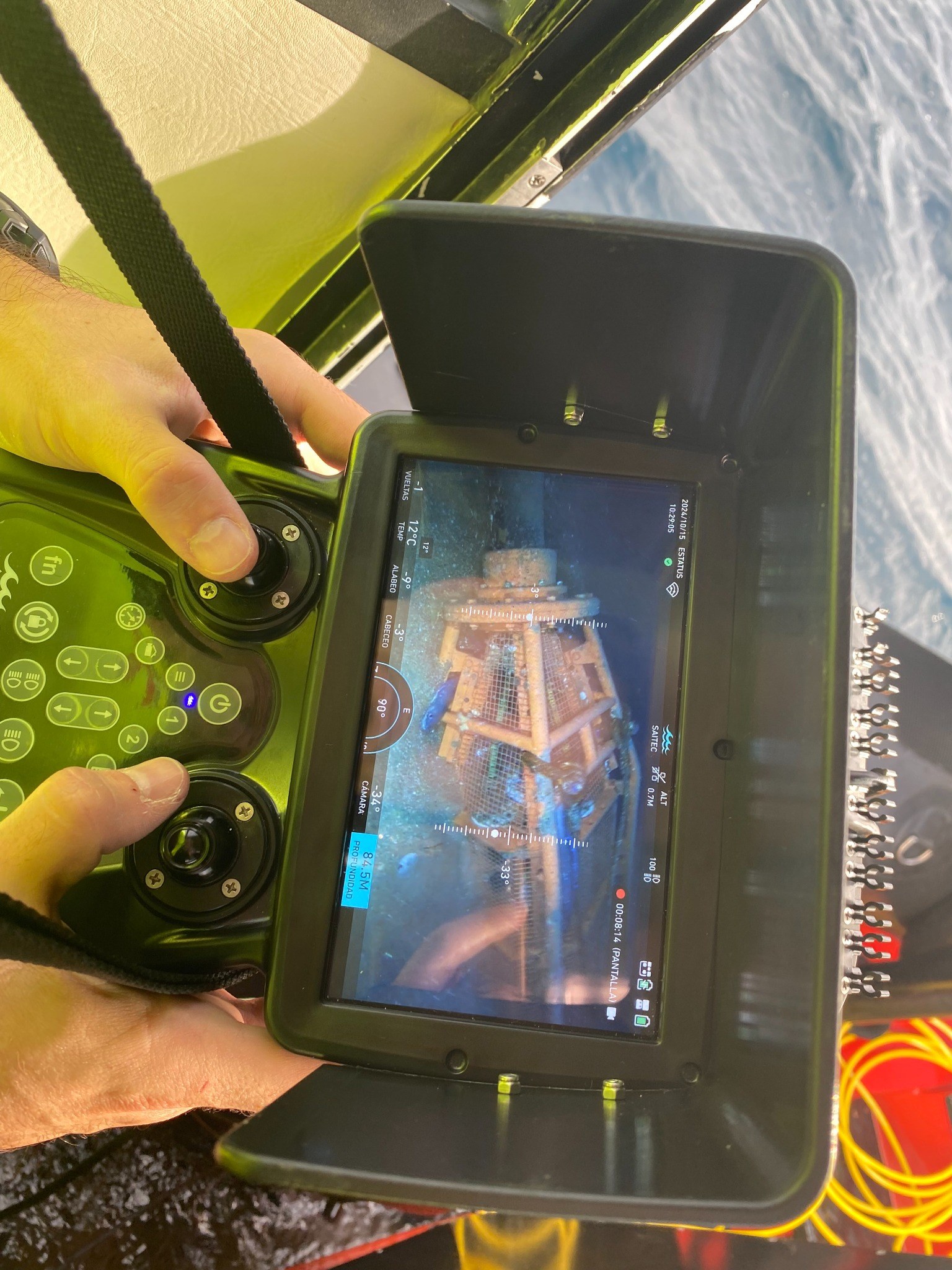 ROV control screen showing an underwater inspection view of a biodiversity structure with marine life.